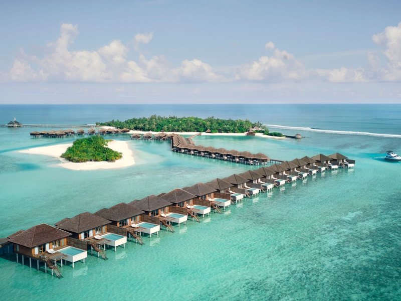 A long row of overwater villas, from the air
