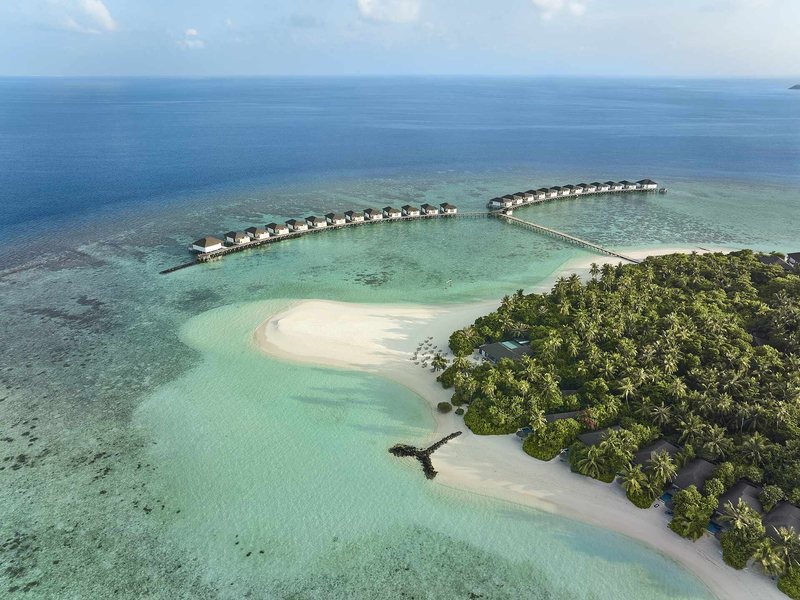 The island, its sandbank and two rows of water villas, from the air