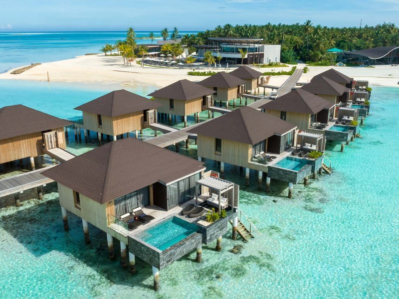 Overwater villas, each with its own pool, the island behind