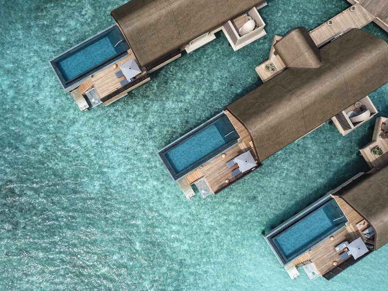 Overwater villas with pools on their decks, from directly above