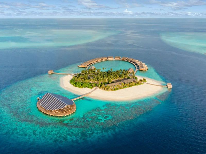 The island and its arc of overwater residences, from the air