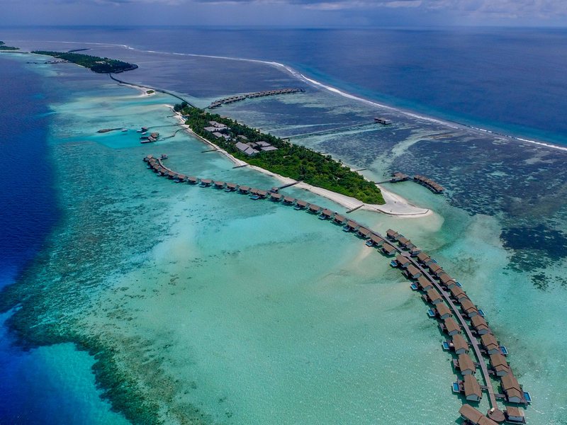 The island and its long arms of water villas, from high above