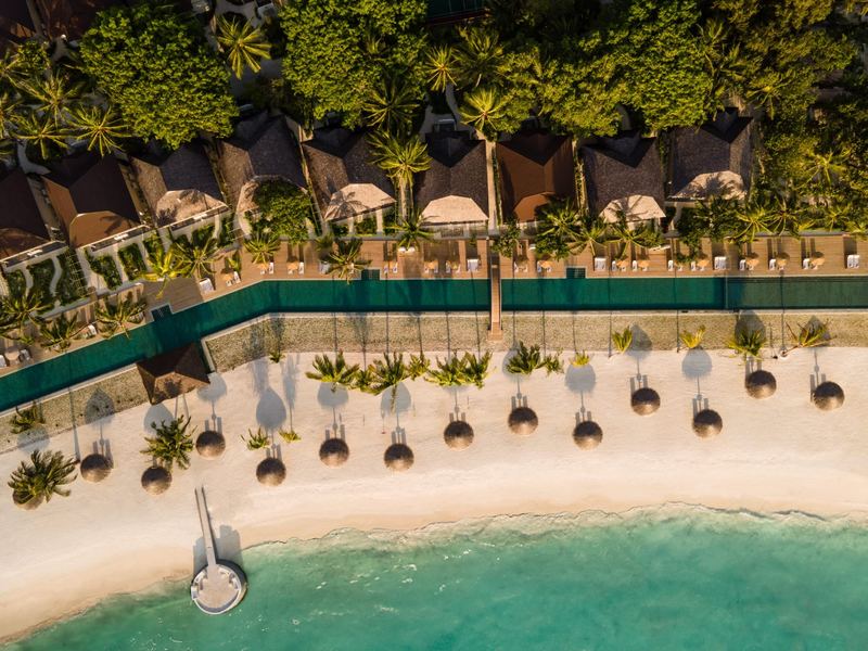 Beach villas and a pool by the sea, from above