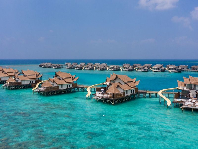 Overwater villas with slides in the lagoon, from the air