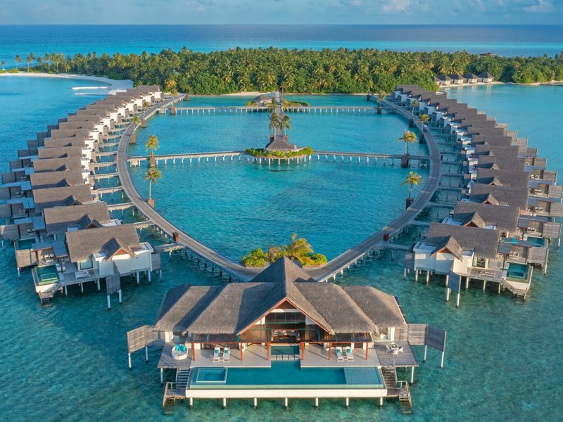 Two curving rows of overwater pool villas, from the air