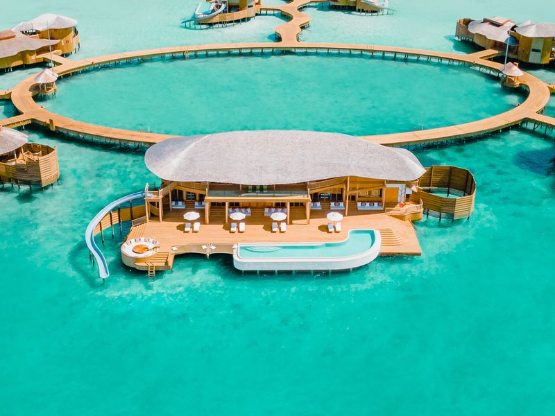 A water villa with its pool and slide, from the air