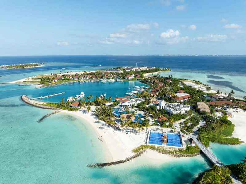 The island, its lagoon and overwater villas, from high above