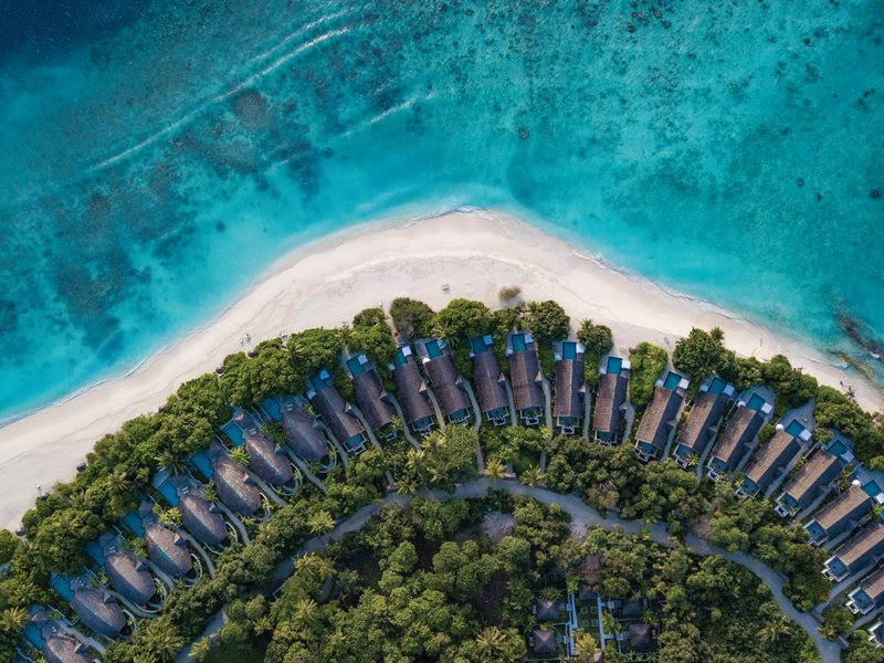 Beach villas along the curve of the island, from above