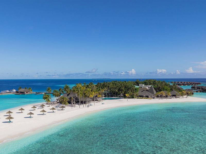 The island’s beach and overwater villas