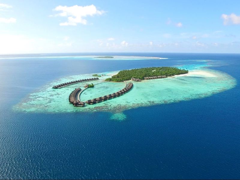 The island and its overwater villas, from the air