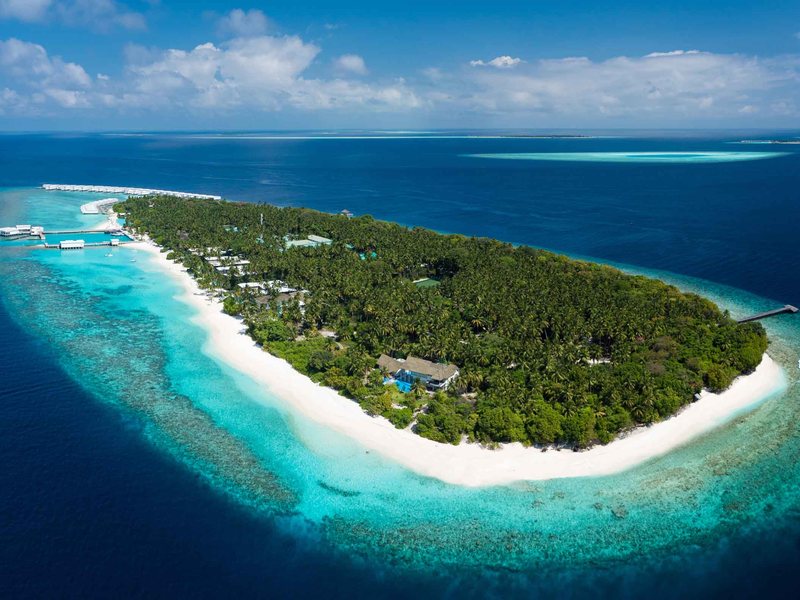 The island ringed by its beach and reef, from high above